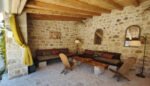La Loggia, the large open lounge, decorated in pure Mediterranean style, in massive stone, precious wood, wrought iron and marble and high quality natural fabrics.